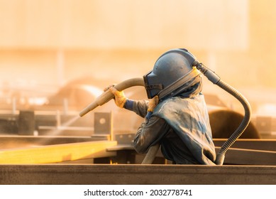 Sand blasting process, Industial worker using sand blasting process preparation cleaning surface on steel before painting in factory workshop. - Shutterstock ID 2032778741