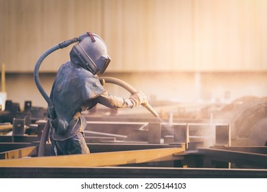 Sand Blasting Process, Industial Worker Using Sand Blasting Process Preparation Cleaning Surface On Steel Before Painting In Factory Workshop.