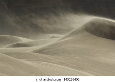 Sand blowing over sand dune in wind