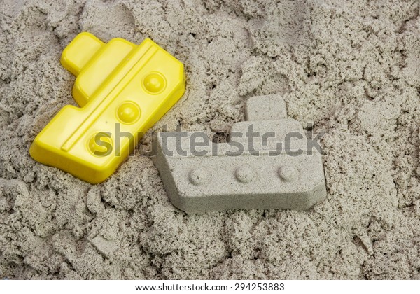 Sand Boat And Plastic Mold On The Sea Beach Close-up\
High Angle View