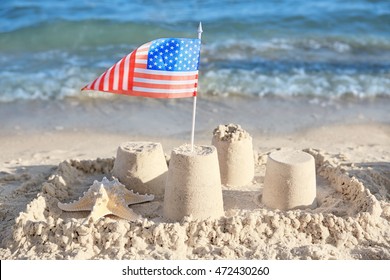 Sand Castle With American Flag On Beach