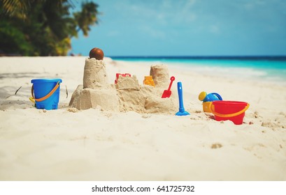 Sand Castle On Beach And Kids Toys