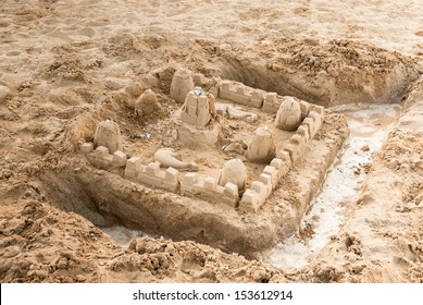 Sand Castle On A Beach With Moat