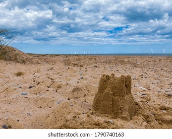 Sand Castle On The Sand's Hills On Great Yarmouth Beach In A Cold Summer Day, Traditional UK, English East Coast, Sky With Clouds No People, Large Stretch Of Sand, UK Beaches View Of The North Sea 