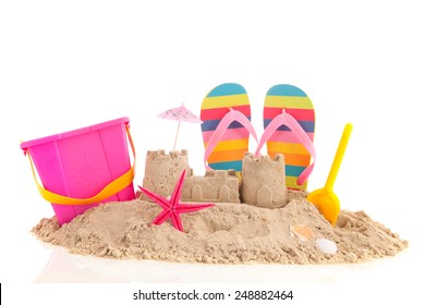 Sand castle and toys at the beach isolated over white background - Powered by Shutterstock