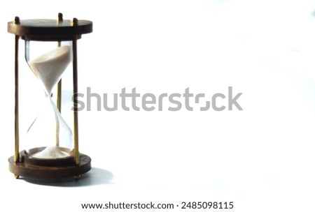 sand clock , sand timer or hourglass with white sand on a white background  place at left sideleft
