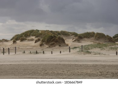 Sand drift and gray sky on a summer day in July