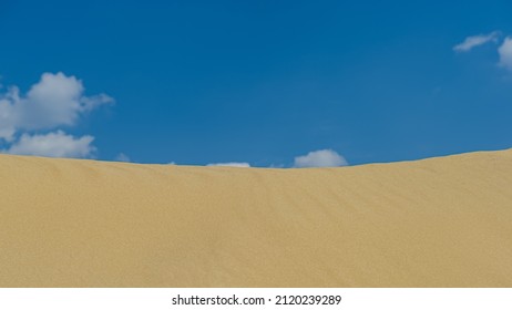 Sand dune and blue sky. Spring season, April. Web banner.