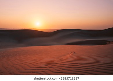 Sand dunes against sky at sunrise. Desert Wahiba Sands in Sultanate of Oman.
 - Powered by Shutterstock