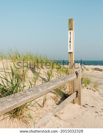 Sand dunes and Kismet sign on the beach, in Fire Island, New York City