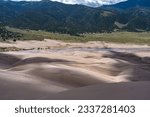Sand dunes with the Medano creek flowing down in waves. Shot in the Grand Sand Dunes National Park, Colorado state in early June.
