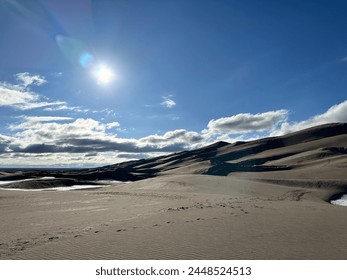 Sand dunes with sun and clouds - Powered by Shutterstock