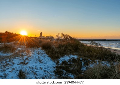 Sand dunes at sunset in the snow, Oostende, Belgium. - Shutterstock ID 2394044477