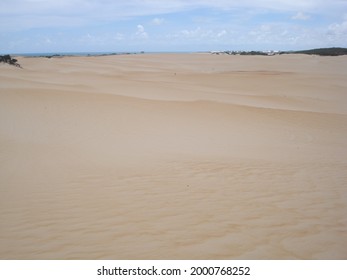 sand dunes with vegetation and clouds