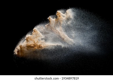 Sand Explosion Isolated On Black Background. Freeze Motion Of Sandy Dust Splash.