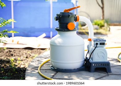 Sand Filter System For Purifying Pool Water On The Background Of A Frame Polyethylene Pool