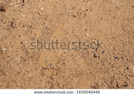 Sand and glass background. Texture ground, dirt, glass background.