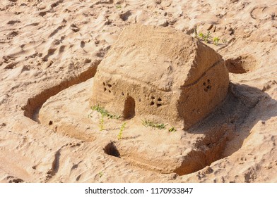 Sand House With A Moat On The Beach