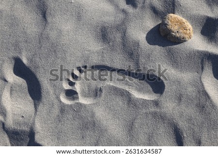 Sand human foot print at La Cinta beach in Sardinia Costa Smeralda region in Italy.