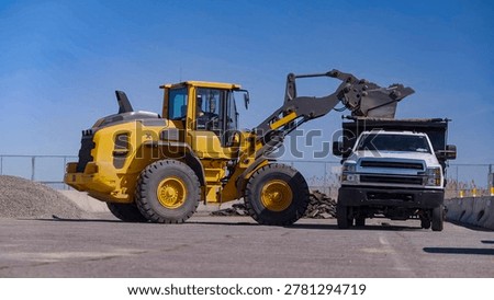 Sand loading process with front loader and dump truck