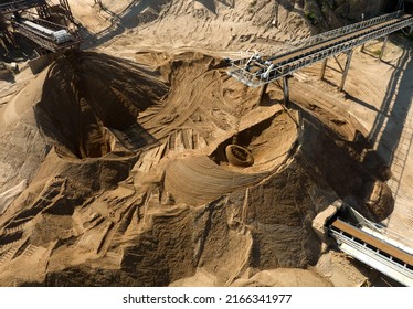 Sand Making Plant and Belt conveyor in mining quarry. Sand crushing and bulk materials for construction. Screening and washing in open-pit mining. Stone jaw crusher plant. Stone crushing plant.