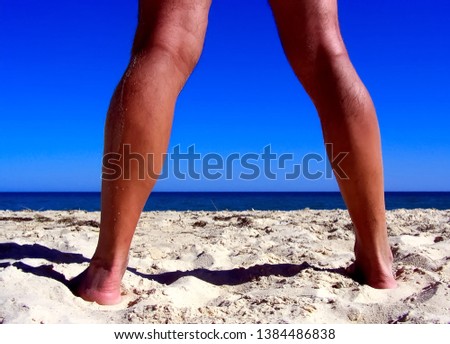 
Sand, ocean, sky and legs