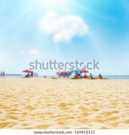 Sand on the beach and sun in blue sky. Soft focus on bottom of picture.  Ukrainian Black Sea view.