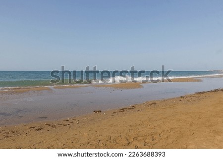 Sand on the sea coast in Turkey. Texture of beige sand on a sunny day can be used for background