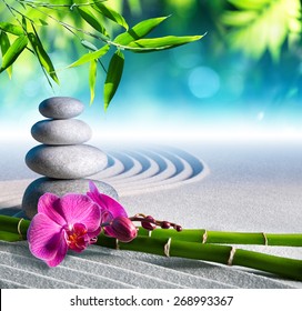 Sand, Orchid And Massage Stones In Zen Garden
