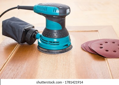 Sand Paper And Sand Machine Remove Varnish From Old Furniture. Electrical Tools Of Carpenter Joiner And Restorer.