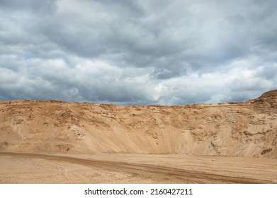 a sand quarry, in the photo a sand quarry and a gray sky in the background.