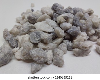Sand quartz or gravel silica sand isolated on white background. Quartz sand known as sand filter is used in finishing construction materials, water filter treatment and agriculture