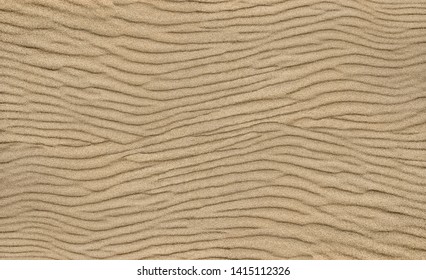 Sand ripple texture. Sandy background. Sand close-up.