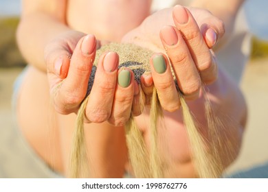 Sand Running Through Hands Of Woman. Lost Time Concept