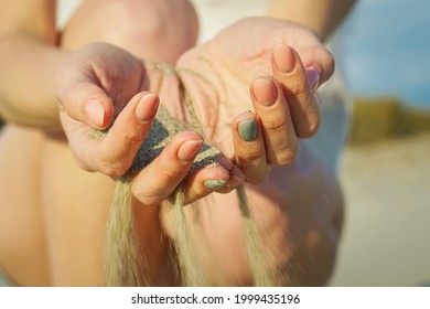 Sand Running Through Hands Of Woman. Lost Time Concept