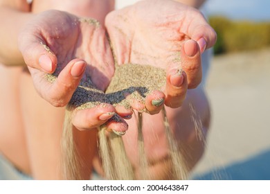 Sand Running Through Hands Of Woman. Lost Time Concept