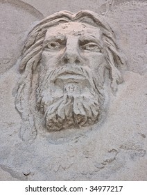A sand sculpture at the beach of the face of Jesus