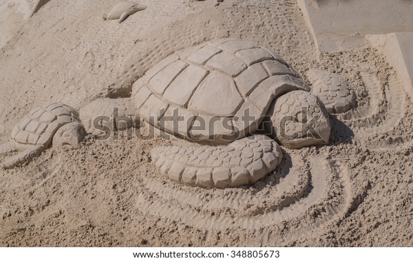 Sand Sculpture of a Mother Sea Turtle and Her\
Baby Sea Turtle on Fort Myers\
Beach