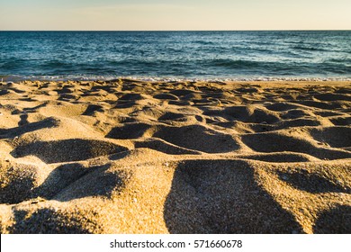 Sand and sea - Shutterstock ID 571660678