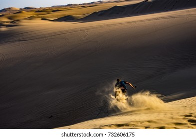 Sand skiing and doing a jump on a sand dune  - Powered by Shutterstock