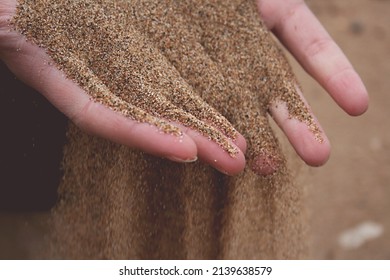 Sand Slipping Through Womans Fingers.