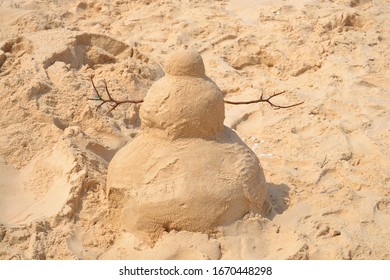 sand snowman on the same beach