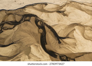 Sand and soil pattern in dry river bed from a bird's eye view, best for background.