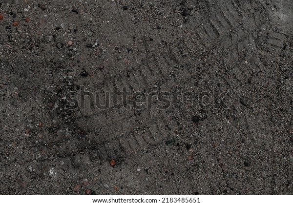 sand stone texture background. Sand texture\
from heap of sand. Traces of the protectors of heavy industrial\
machinery on sand.\
Background.