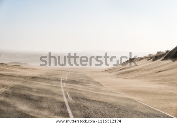 Sand Storm Across Lonely Desert Road in\
Southern Namibia taken in January\
2018