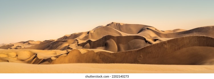 Sand storm and bad weather in Namib desert, panoramic landscape of Sandwich Harbour with motion sand flying at high hills. Windy weather over sand dunes in a desert, Namibia. Wilderness in Africa. - Shutterstock ID 2202140273