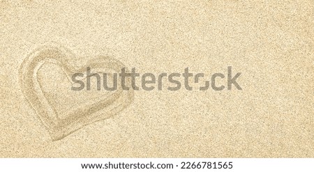 Sand. Texture, surface of sea sand. A heart drawn in the sand. Natural background. Close-up. View from above. Smooth. Space for text. Copy space