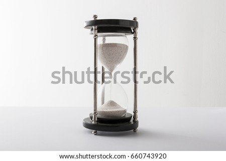 A sand timer on the white background.