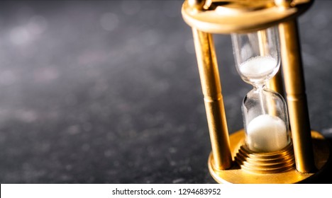 Sand Trickles Through An Hourglass, Symbolizing Timekeeping.