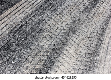 Sand Tyre Mark On Black Asphalt Texture.